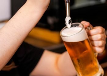 close-up-of-barman-hand-at-beer-tap-pouring-a-draught-lager-beer.jpg